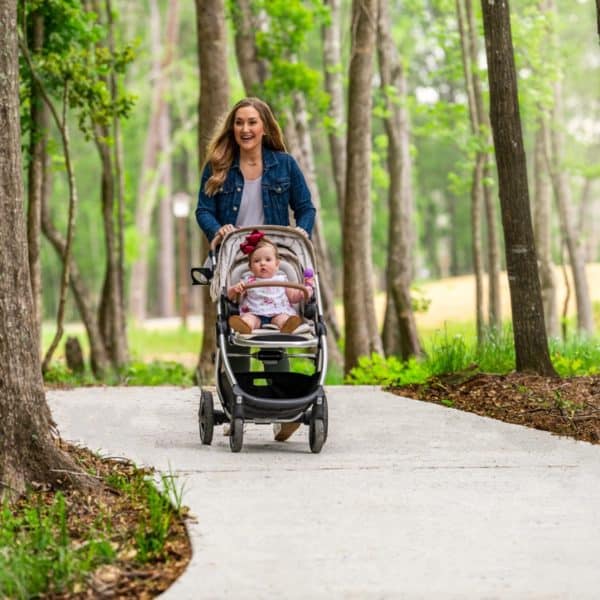 mom walking with daughter on paved trail