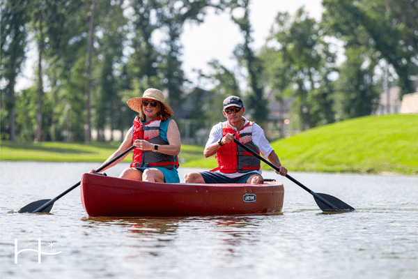 a couple canoeing at an active adult retirement living in texas